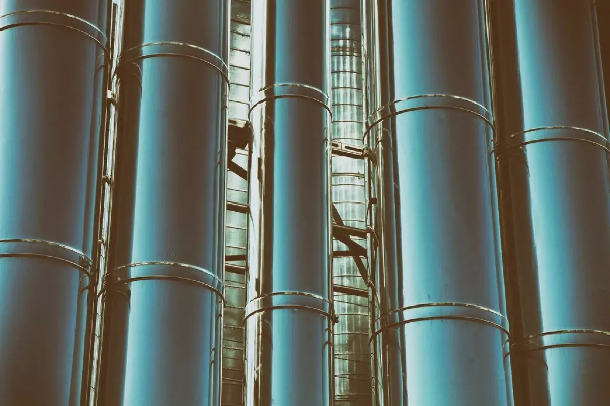 A row of stainless distillation columns seen close up